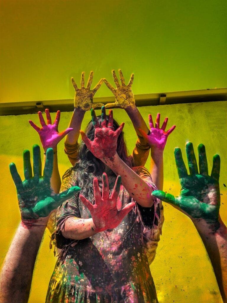 photo of four people showing painted hands